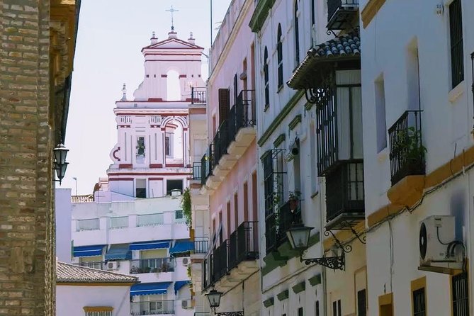 Sevilla Food Tour: Tapas, Wine, History & Traditions - Plaza del Pan: a quick look at traje de flamenca and Feria tradition
